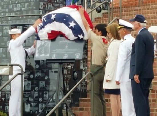 A group of people standing around a flag.