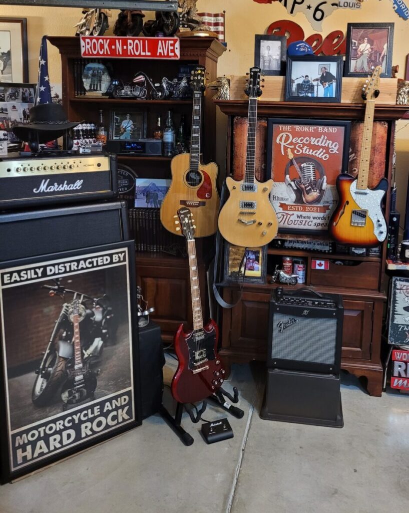 A room filled with guitars and amps on display.